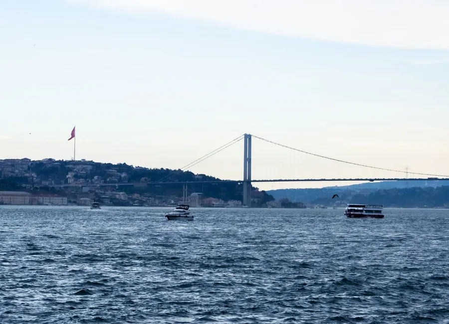 Bosphorus Bridge and boats on the strait in Istanbul, Türkiye